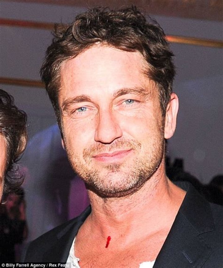 Bloody Gerard Butler attends Versace New York store opening with big