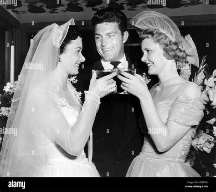 Bride Frederica Jacqueline Wilson (left) is toasted by her sister and
