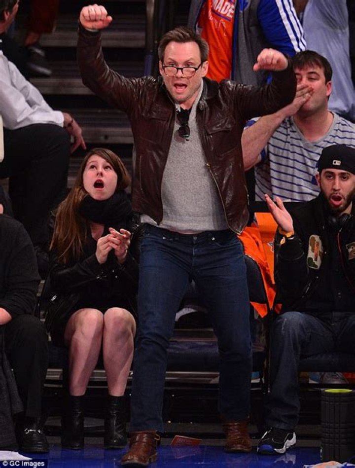 Daddy fool! Passionate Christian Slater punches the air in delight as