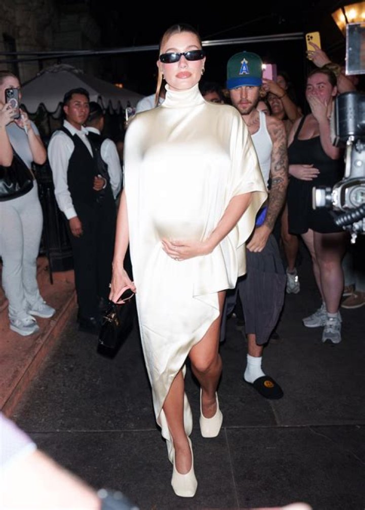 Hailey Bieber&rsquo;s growing baby bump pops out of tight black romper on