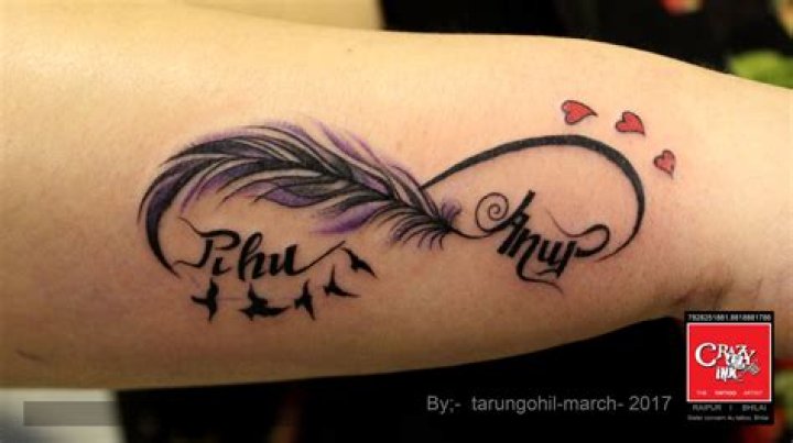 infinity feather tattoo with name on wrist done at crazyink tattoo