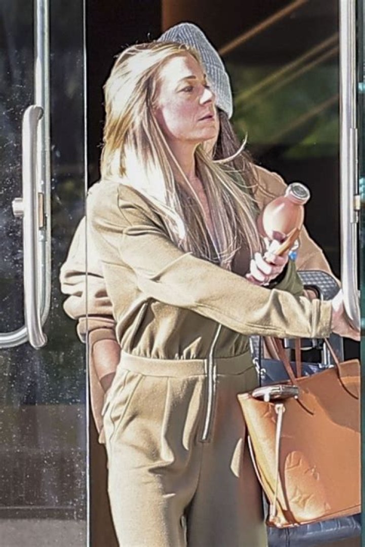 LeAnn Rimes displays tan lines in lacy offtheshoulder top at fashion