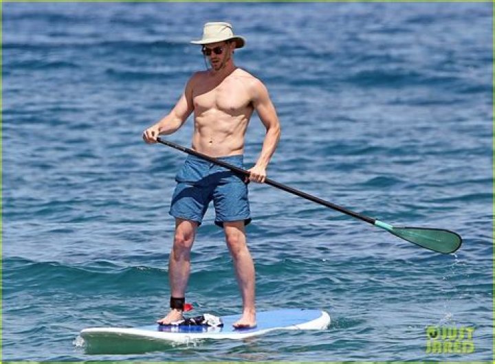 Matt Bomer shirtless while paddleboarding with husband Simon Halls