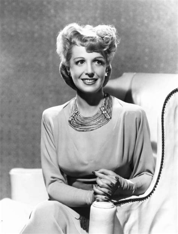 Natalie Schafer Modeling A Necklace Made Of Beige Fringe And Gold Beads