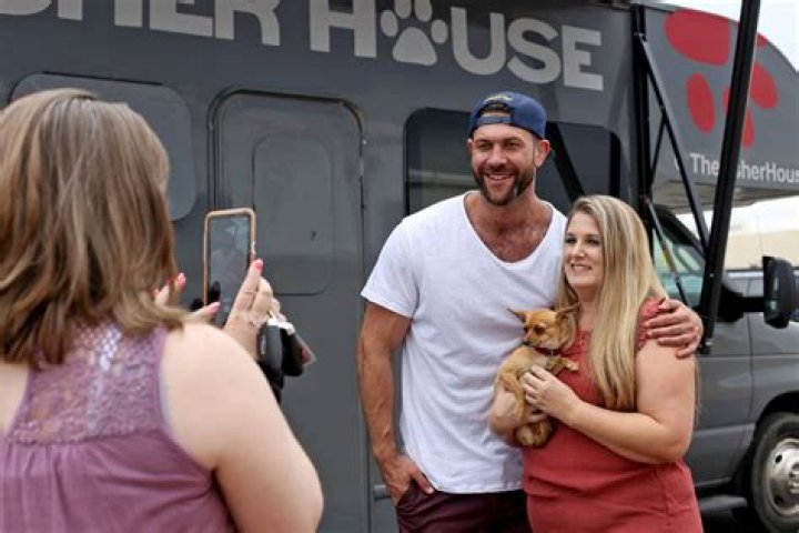 Renne Babiracki, of Oregon, takes a photo with Lee Asher while holding